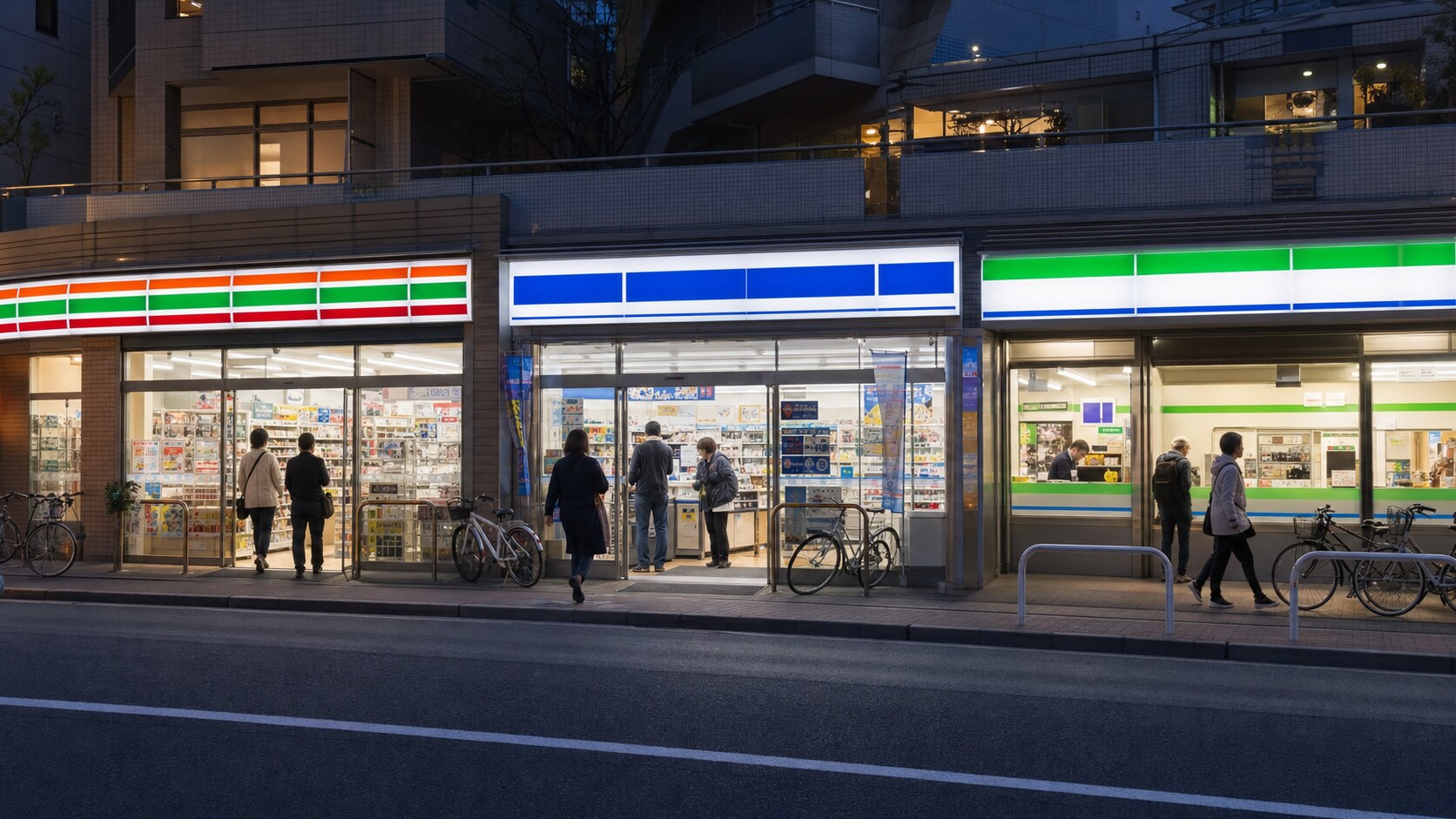 Three brightly lit Japanese convenience stores with customers and parked bicycles on a Tokyo street at dusk